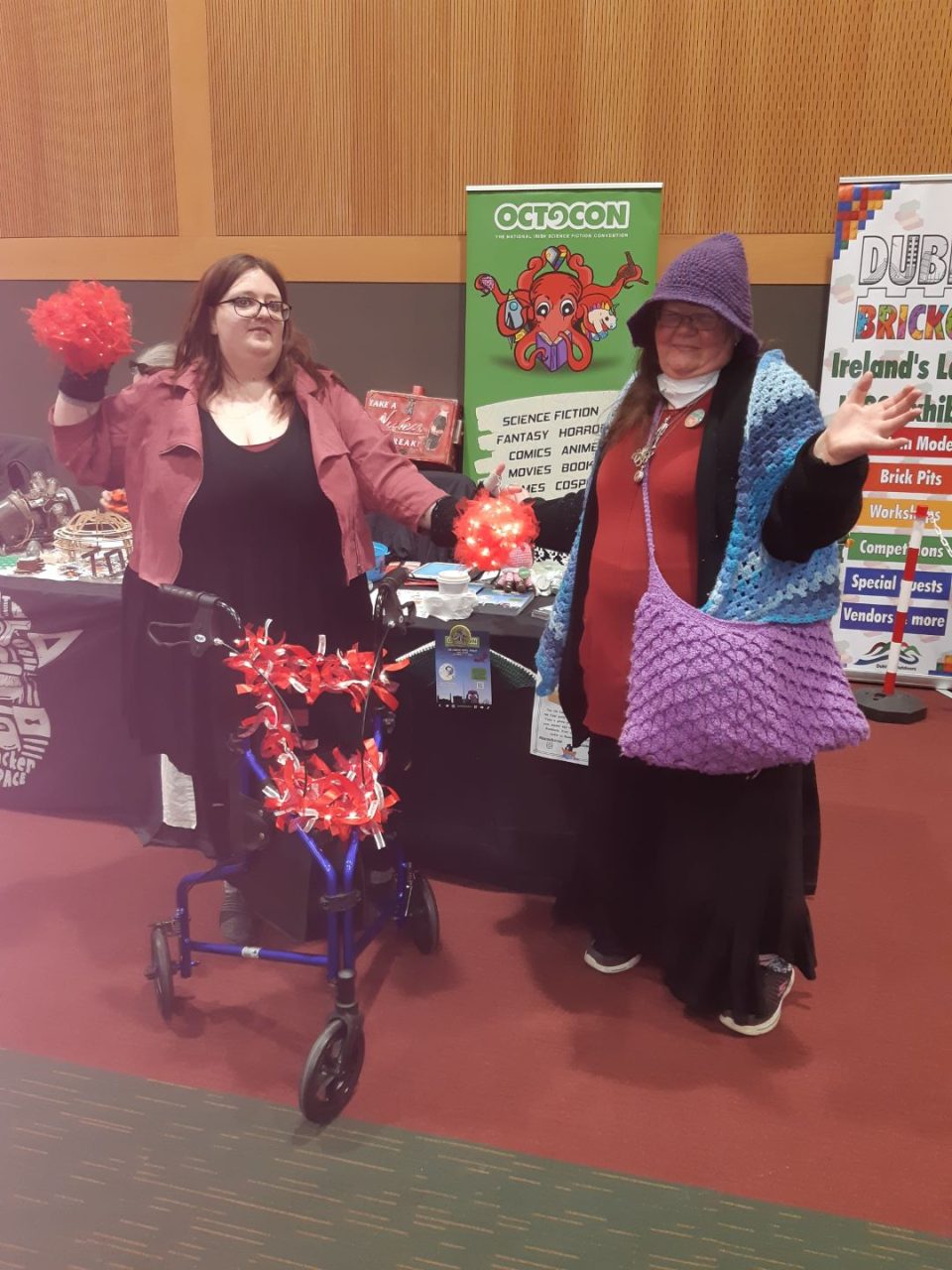 Kat as Wanda and MaryBrigid as Mother Goose at the Octocon fan table